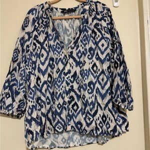 Thin, blouse. Scrunched sleeves at the wrist. Half way button down.